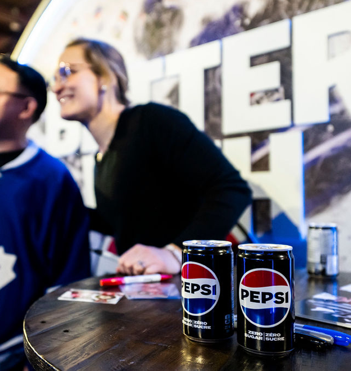 Pepsi cans sitting on a table at an event