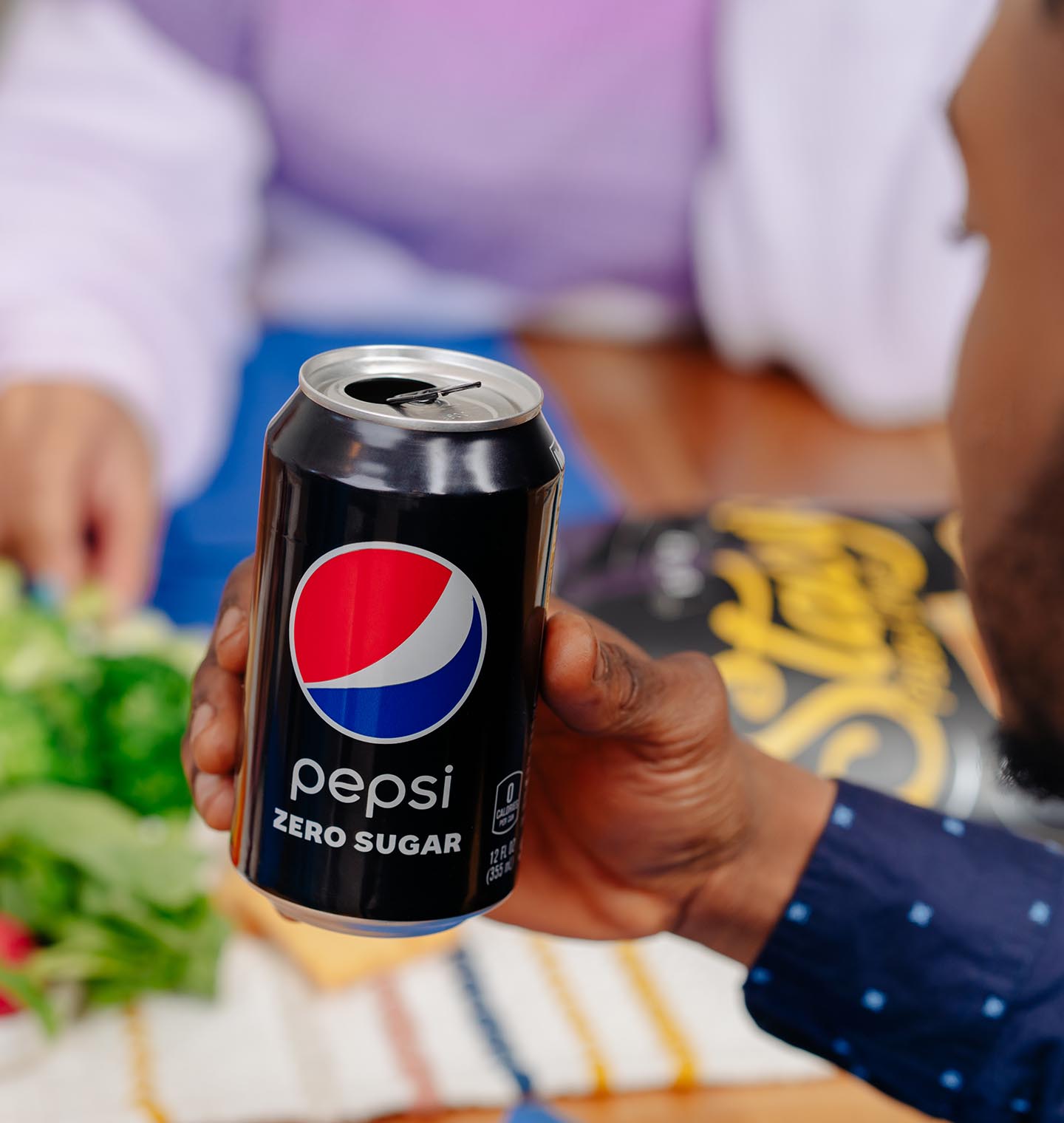 Man drinking a pepsi zero sugar at a party