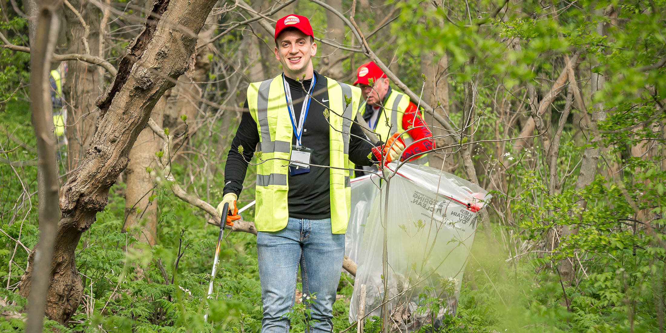 Employees picking up trash in the woods